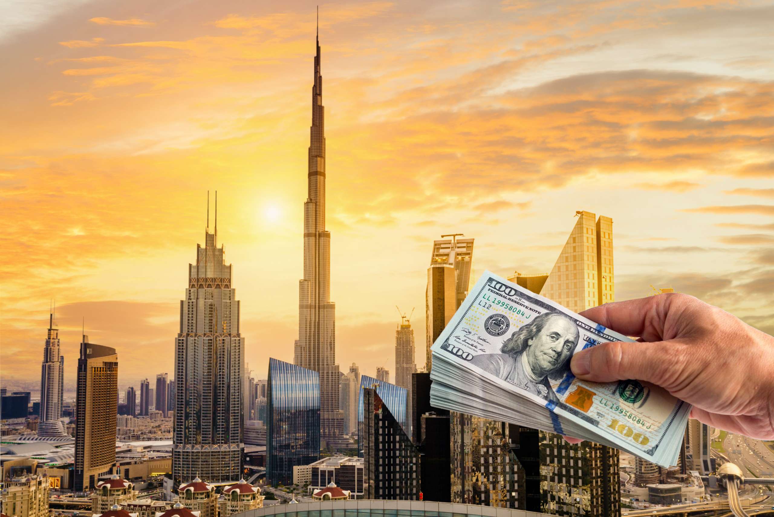 Skyline of Dubai With a Hand holding Money to Pay for Real Estate Investment
